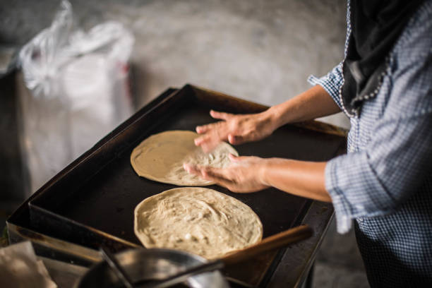 istock Flour is fried for making roti in a breakfast restaurant in Narathiwat 1324706648