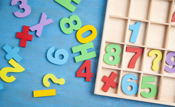 istock Colorful numbers on blue wooden table. Education 1324706851