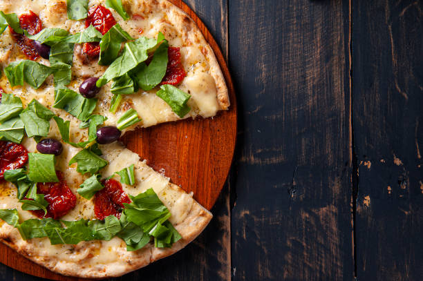 istock Brazilian-style pizza with mozzarella, sun-dried tomatoes and arugula. Top view. Copy space 1324706899