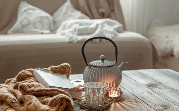 istock Teapot with tea and candles on the wooden table. 1324706989