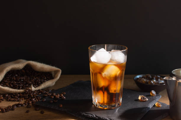 istock Iced coffee in a glass on black background. 1324707600
