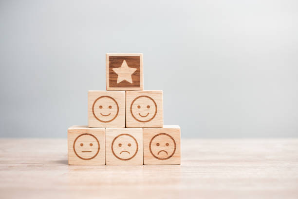 istock emotion face and Star symbol blocks on table background. Service rating, ranking, customer review, satisfaction, evaluation and feedback concept 1324708528
