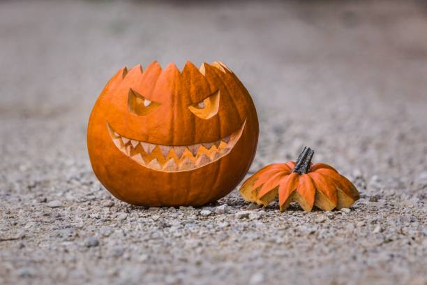 istock Scary smiling halloween pumpkin with nasty face on ground 1324708766