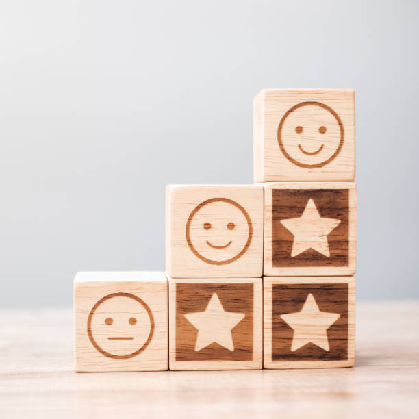 istock emotion face and Star symbol blocks on table background. Service rating, ranking, customer review, satisfaction, evaluation and feedback concept 1324709375