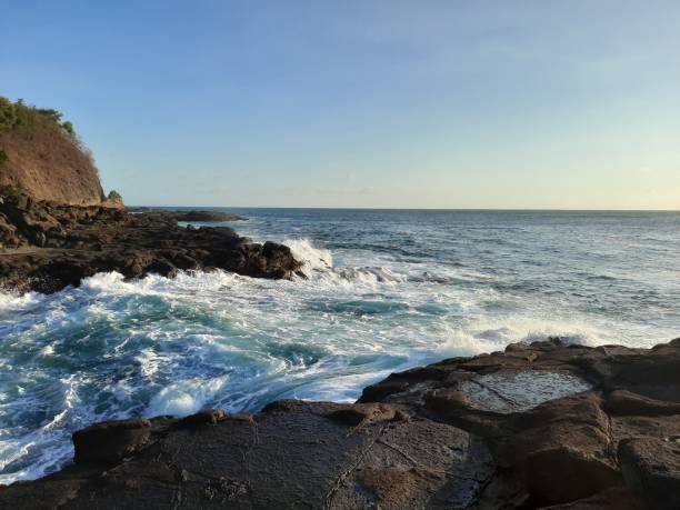 istock Big waves flowing fast between a rock plateau and peninsula 1324709791