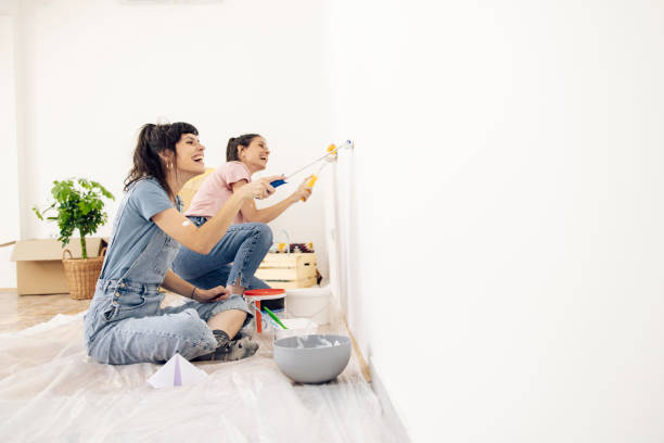 istock Twins having fun while painting their new apartment 1324709864