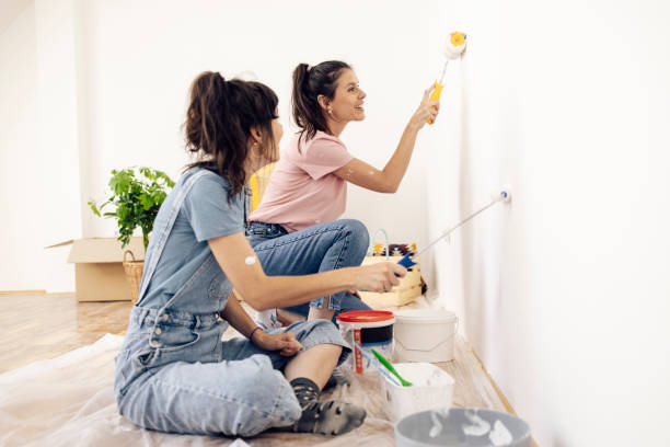 istock Happy twins painting at home 1324709866