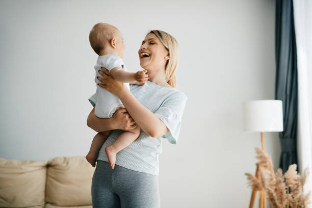 istock Cheerful mother holding her small son while spending time with him at home. 1324709964