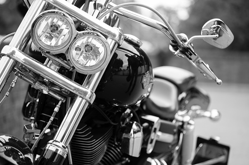 Hamburg, Germany - September 2, 2012: Front view of a parked Harley Davidson with focus of the double headlights, somewhere in Hamburg, Germany. Black and white image.
