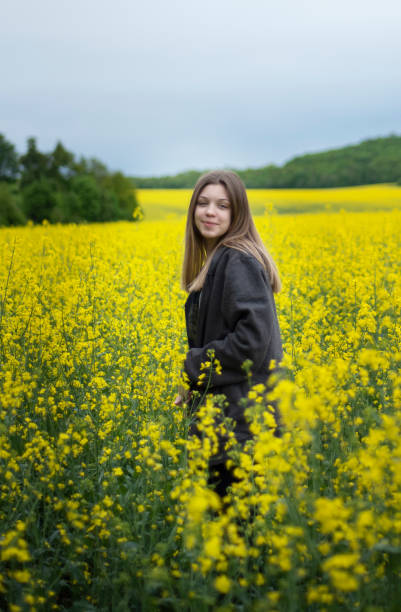 istock Young girl on yellow rapeseed field 1324711281