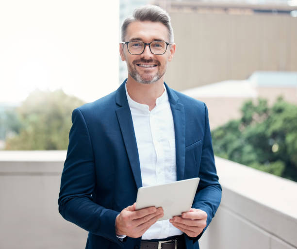 istock Portrait of a mature businessman using a digital tablet outside 1324712146