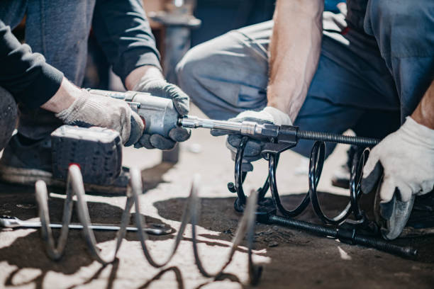 istock spring replacement car suspension repair in the garage. 1324713835
