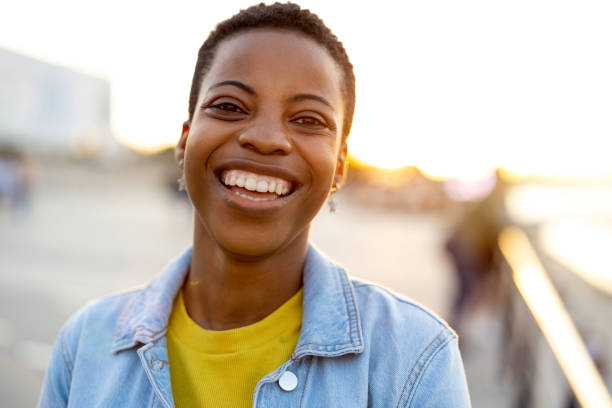 istock Smiling young woman enjoying the outdoors at sunset 1324715848