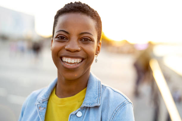 istock Smiling young woman enjoying the outdoors at sunset 1324716928