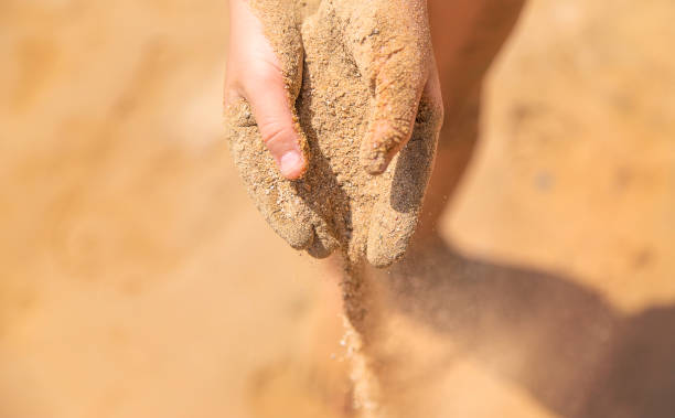 istock Sand in the hands of a child. Selective focus. 1324717535