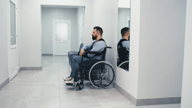 istock Man with disability waiting in clinic corridor 1324717597