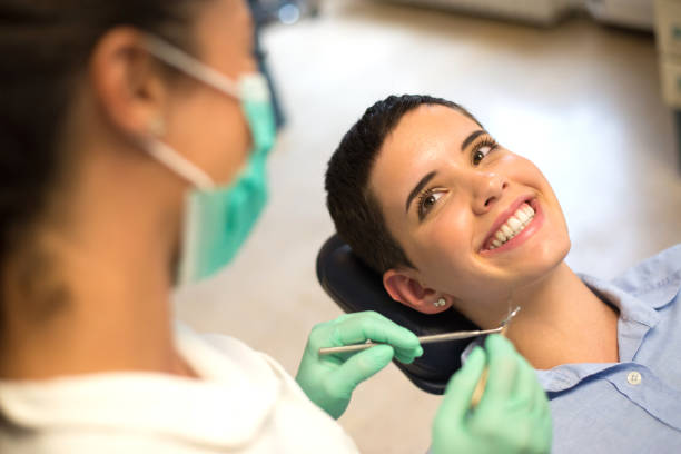 istock Dentist examining teeth of female patient 1324718217
