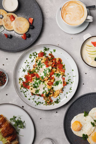 istock Various breakfast options. Scrambled eggs, cheese cakes, milk porridge, coffee 1324722972