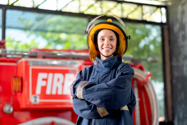 istock Firefighter with protective clothes stand with confidence action and smile in front of fire truck 1324725585