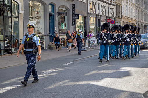 The royal guard marching through the street in the center of Copenhagen. This tradition is taking place every day.