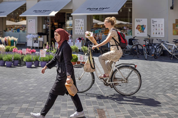 Woman at a bike in the center of Copenhagen. Denmark has always been famous for its many young women on bikes.
