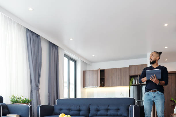 istock Man Controlling Light and Temperature in Apartment 1324725831