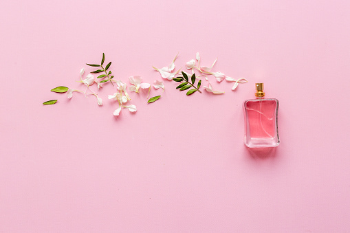 Perfume bottle flat lay with fragrance ingredients, top view
