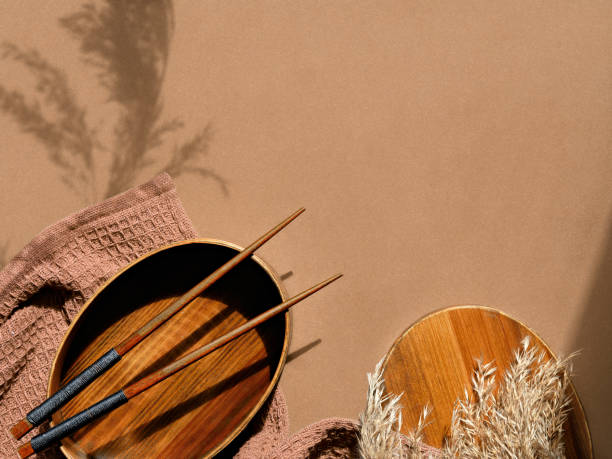 istock Text Packed lunch. Zero waste packed lunch box set on brown paper background. Lunch box, bamboo fork and spoon wrapped in furoshiki textile cloth. Top view, trendy shadows of wild pampas grass 1324727136