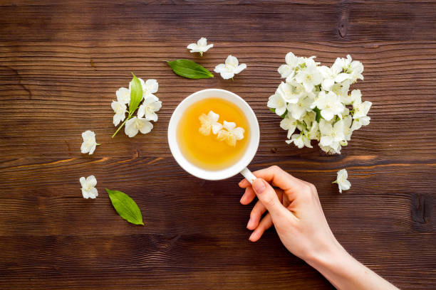 istock Tea in a cup with jasmine flowers. Herbal tea top view 1324729796