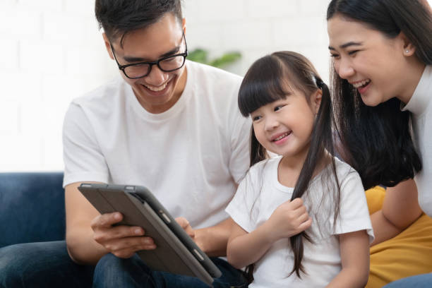 family smiling talking at camera. happy family speak talk on video call from home. - father digital tablet asian ethnicity daughter imagens e fotografias de stock