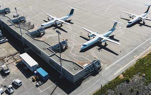 Aerial view of an airport terminal with turbo prop aircraft.