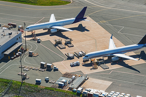 An aerial view of two cargo jets at loading facility.
