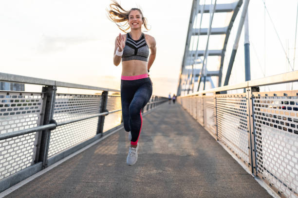 istock Athletic woman jogging at the bridge 1324730328