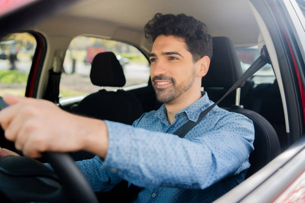 istock Man driving his car on way to work. 1324730620