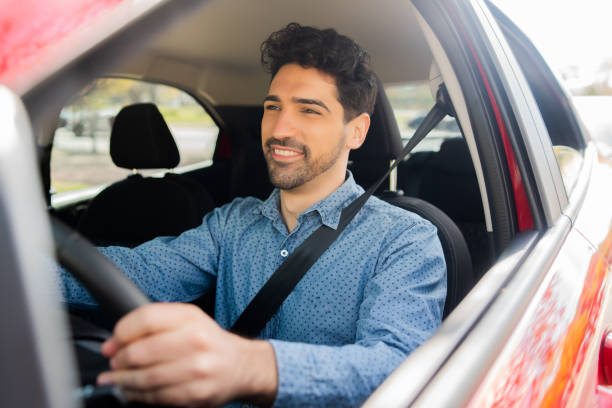 istock Man driving his car on way to work. 1324730639