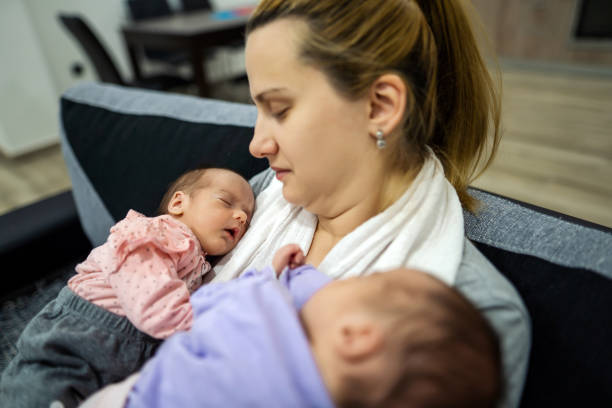 istock Mother holding her twin babies. 1324730767