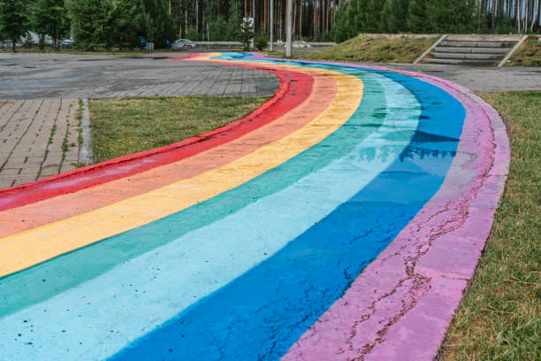 istock rainbow winding wet path with puddles after rain, copy space, colorful background 1324732159