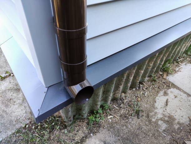 istock new plastic downpipe on an old house sheathed with new siding 1324732949