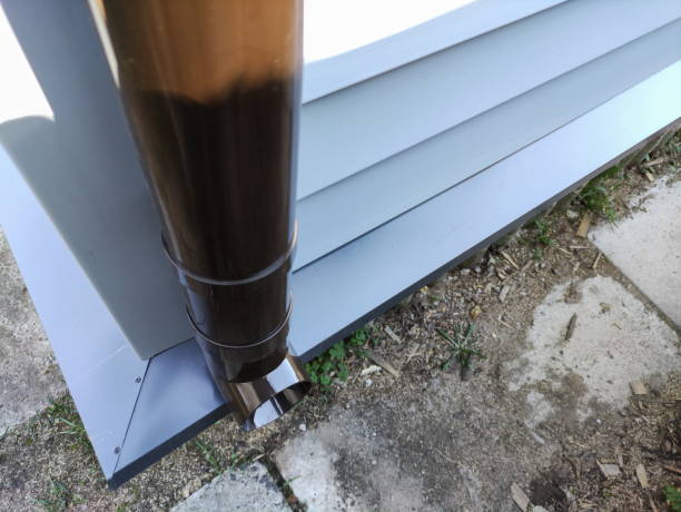 istock new plastic downpipe on an old house sheathed with new siding 1324732959