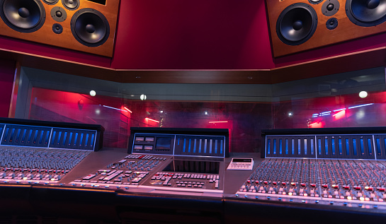 Sliders and knobs at an audio mixing console