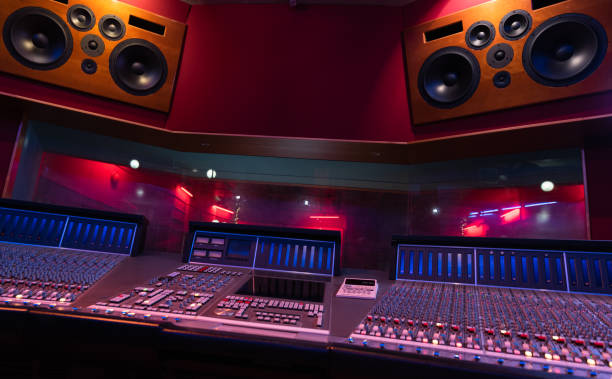 istock Mixing Audio Control Panel, High Power Speakers And View Through Soundproof Window On Musicians 1324733501
