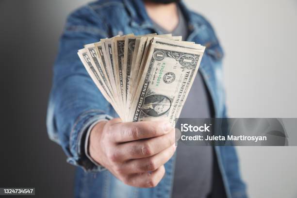Man Holds Money And Shows Stock Photo - Download Image Now - Adult, Adults Only, Business