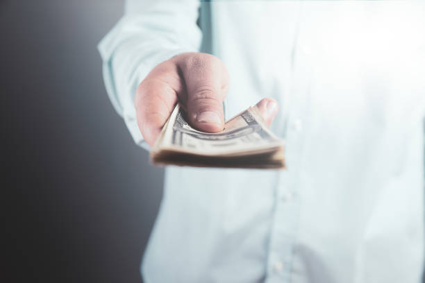 istock man holds money and shows 1324734573