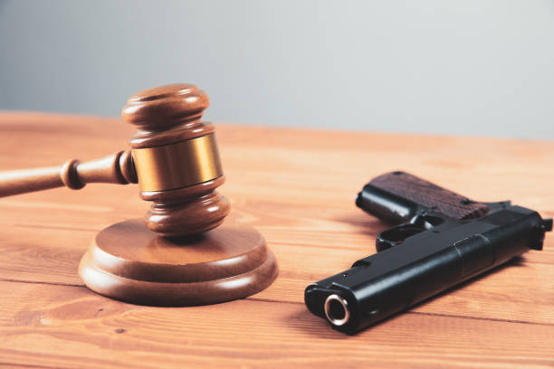 istock court gavel with a gun on the table 1324734587