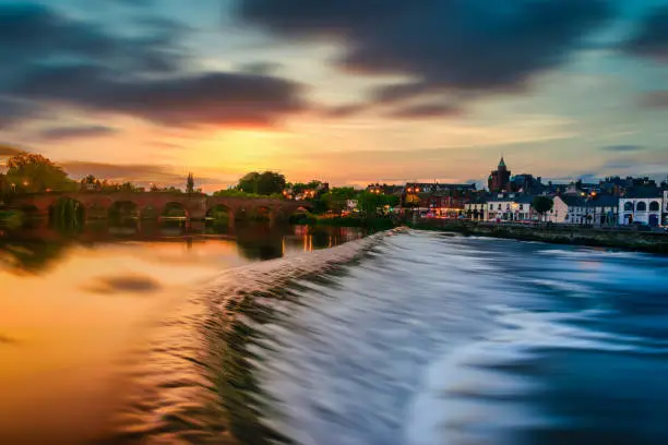 The River Nith and old bridge at sunset in Dumfries, Scotland.