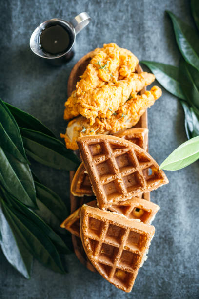 istock Gourmet Chicken and Waffles Plated Restaurant Style with Side of Syrup in Silver Pitcher 1324737149
