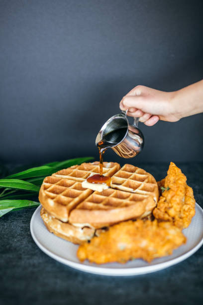 istock Gourmet Chicken and Waffles Plated Restaurant Style with Side of Syrup in Silver Pitcher 1324737237