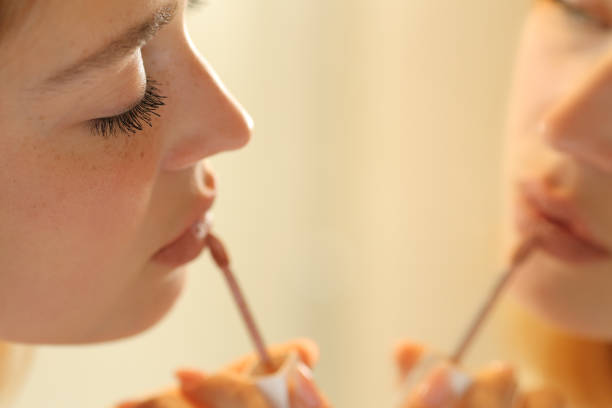 istock Serious woman painting lips applying lipstick 1324737548