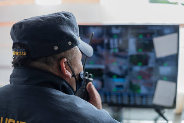 istock Latino man, security guard of a building, received a call by interphone 1324739810