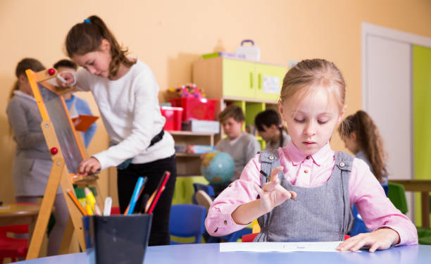 istock Girl drawing in schoolroom during break 1324740966